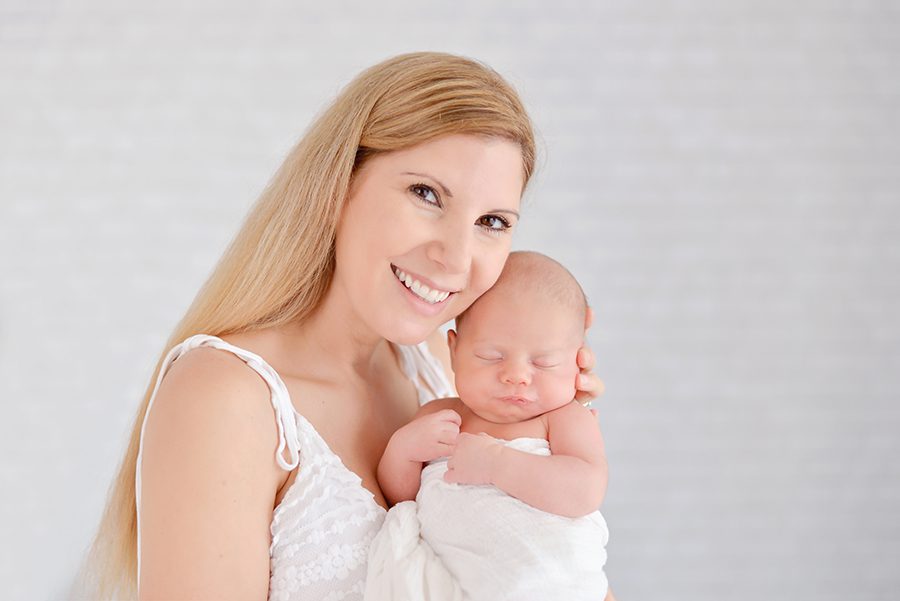 Light, bright, natural in studio newborn session with two sisters, baby boy and their parents
