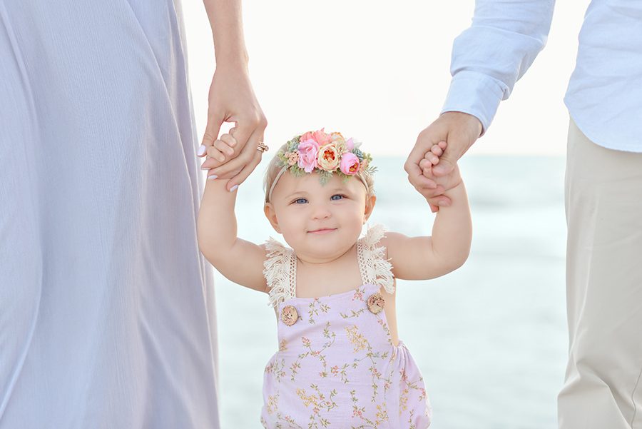 Nine month old baby girl session at the beach. Pastel photo session at Redington Shores. Family photo session at Clearwater Beach.