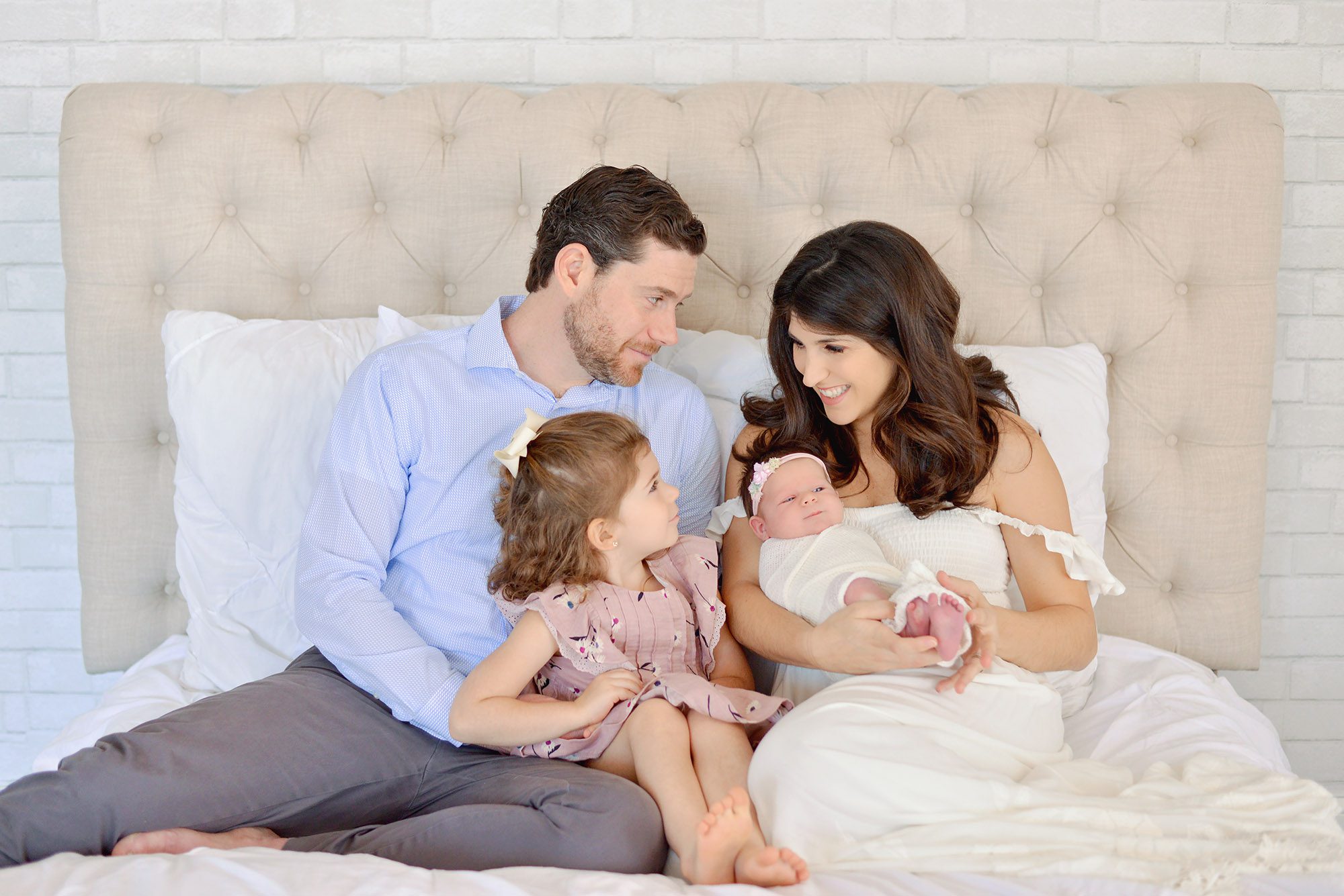 Natural studio newborn session of family with two girls