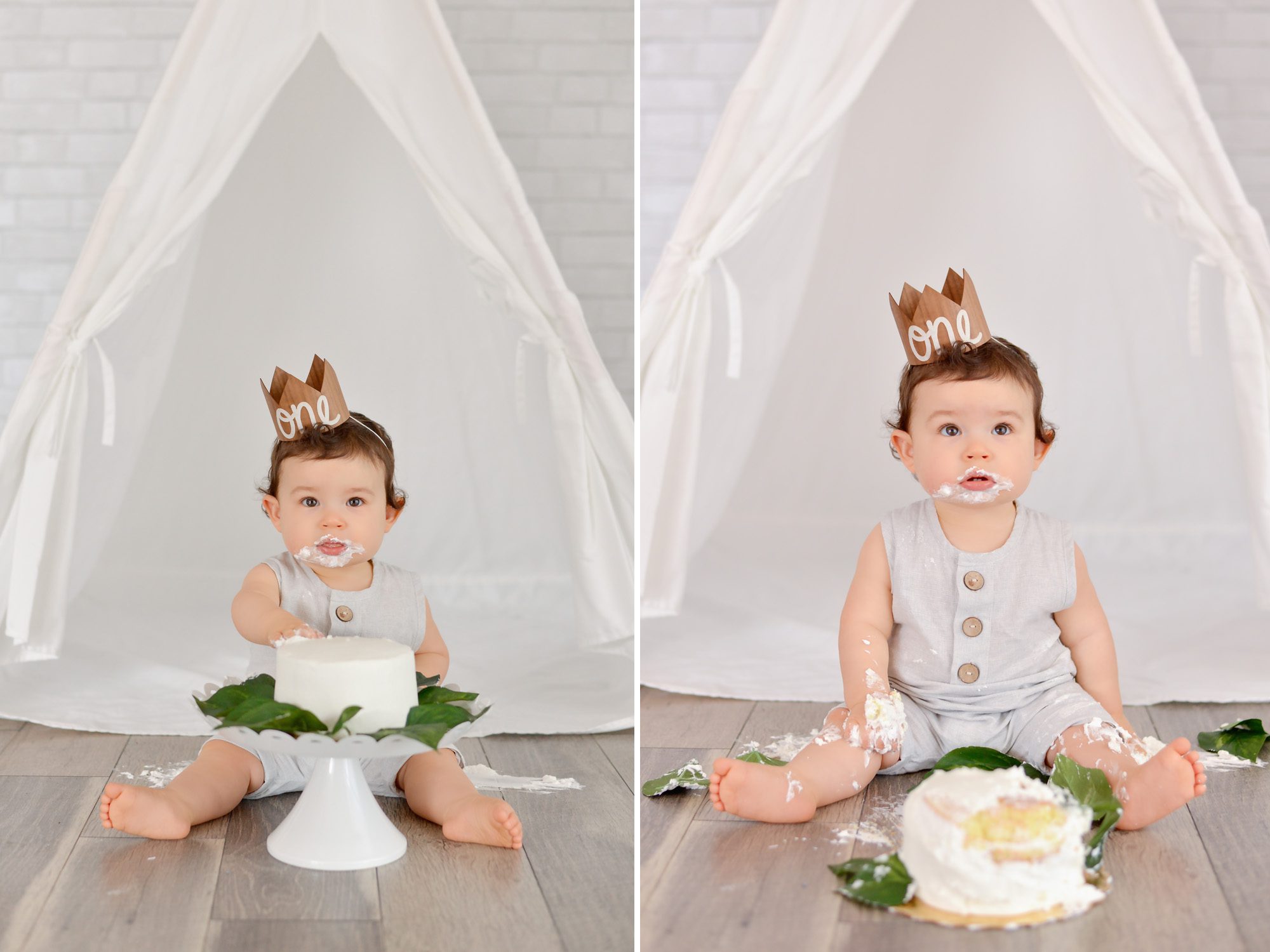 One year old baby boy with dark curls smashes white cake for his first birthday
