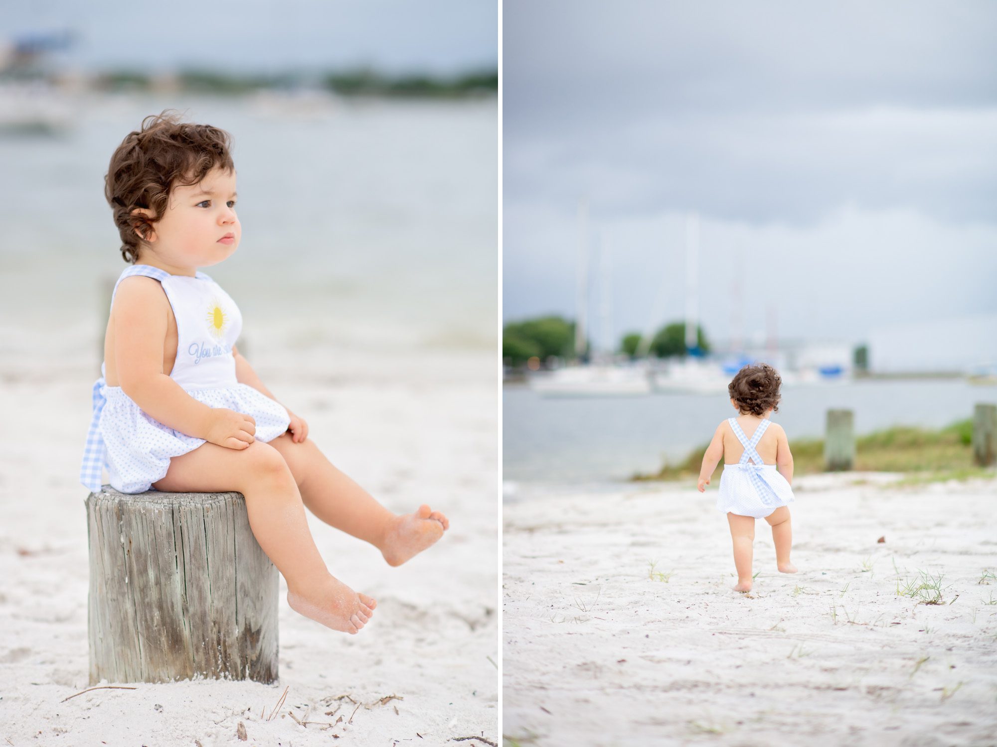 A sweet 18 month old little boy with long dark curls gets his photos taken on an overcast windy day at the beach in Tampa, Florida.