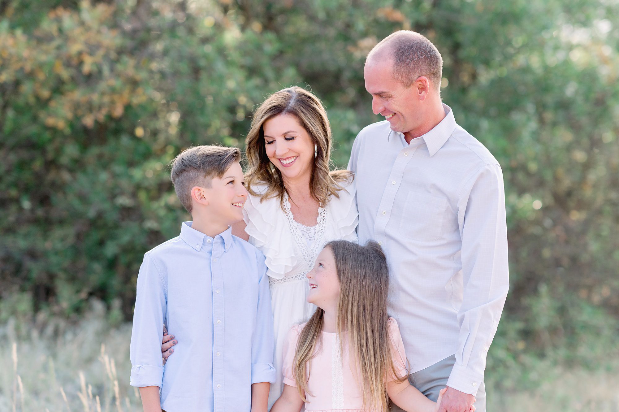 Family of four gets fun natural portraits done at south valley park in Littleton, Colorado