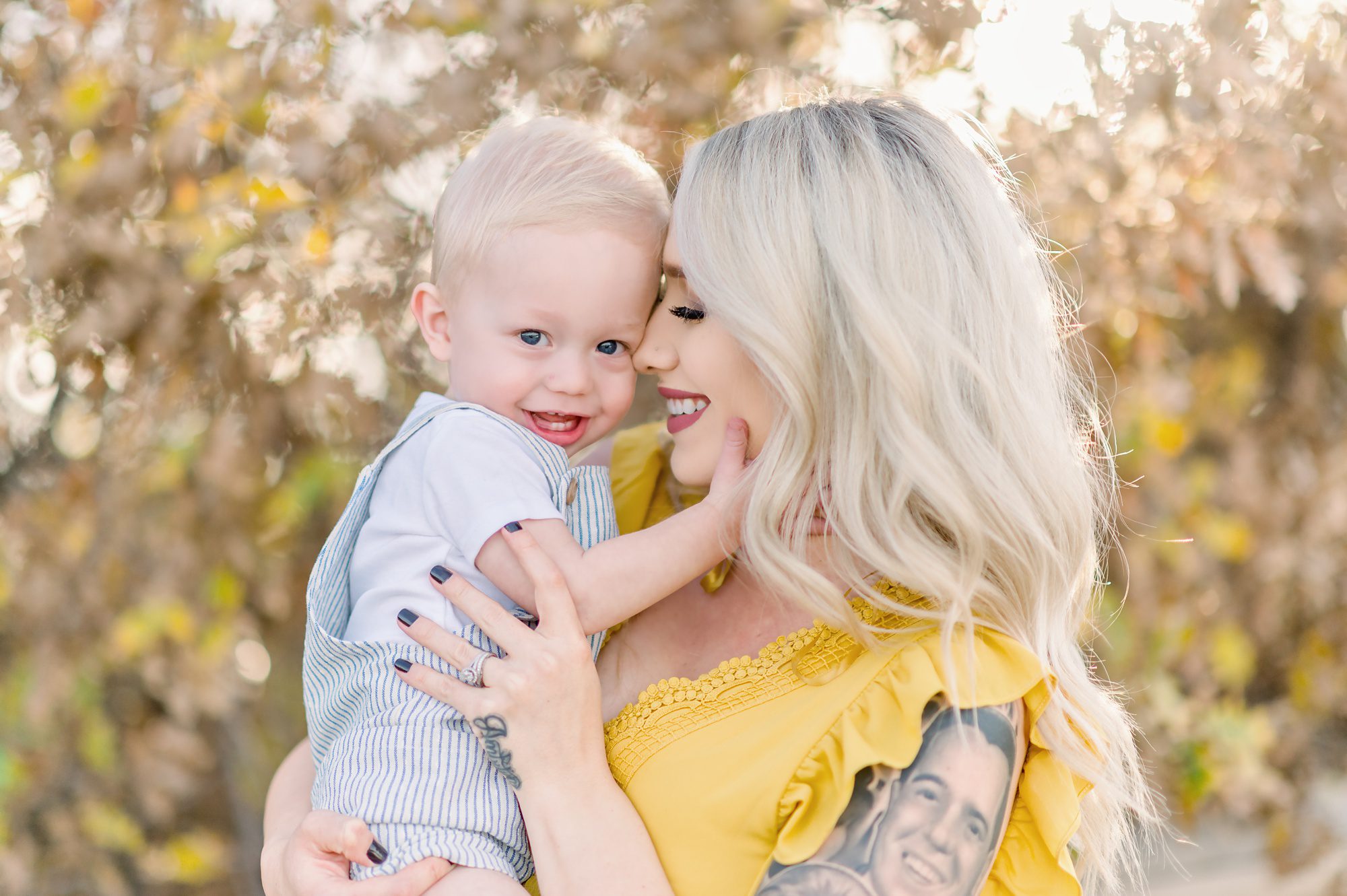 A young mom and her 1 year old son get maternity photos in a picturesque field location in the suburbs of Denver Colorado. 