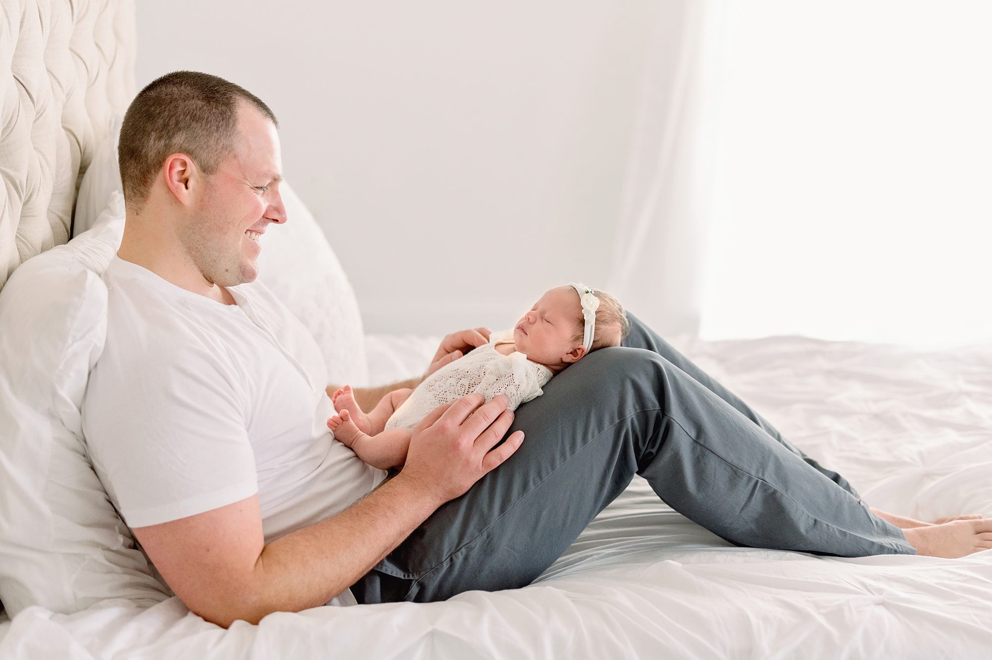 A family of 4 gets natural newborn portraits done in a bright white studio in Denver CO.