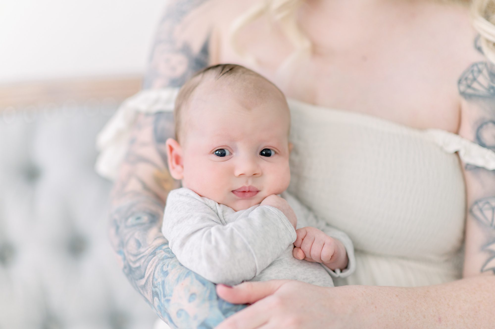 As a new family of 4, these parents get light and airy newborn photos done with their two boys in a bright white studio in Denver Colorado.