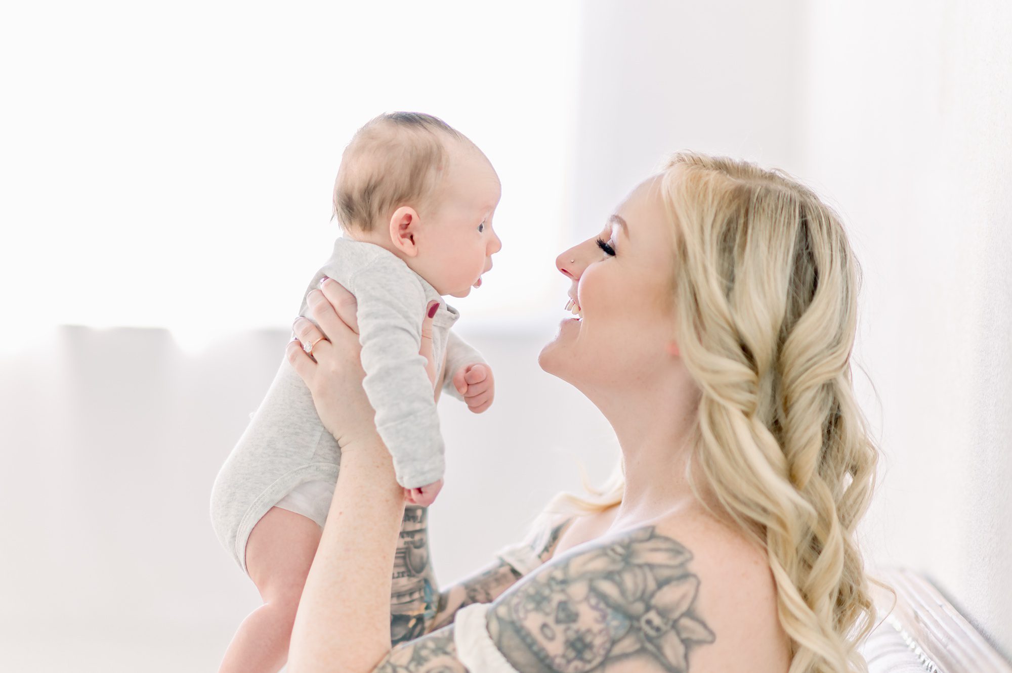 As a new family of 4, these parents get light and airy newborn photos done with their two boys in a bright white studio in Denver Colorado.