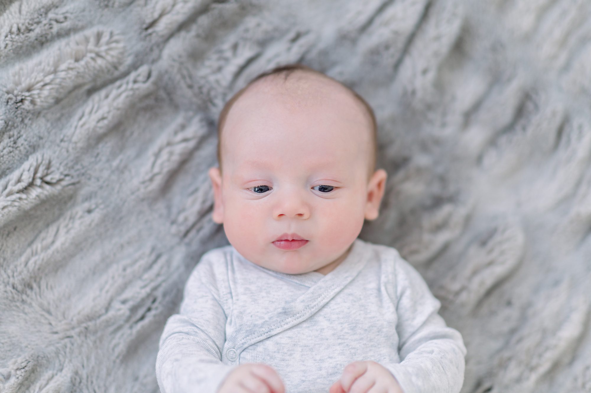 As a new family of 4, these parents get light and airy newborn photos done with their two boys in a bright white studio in Denver Colorado.