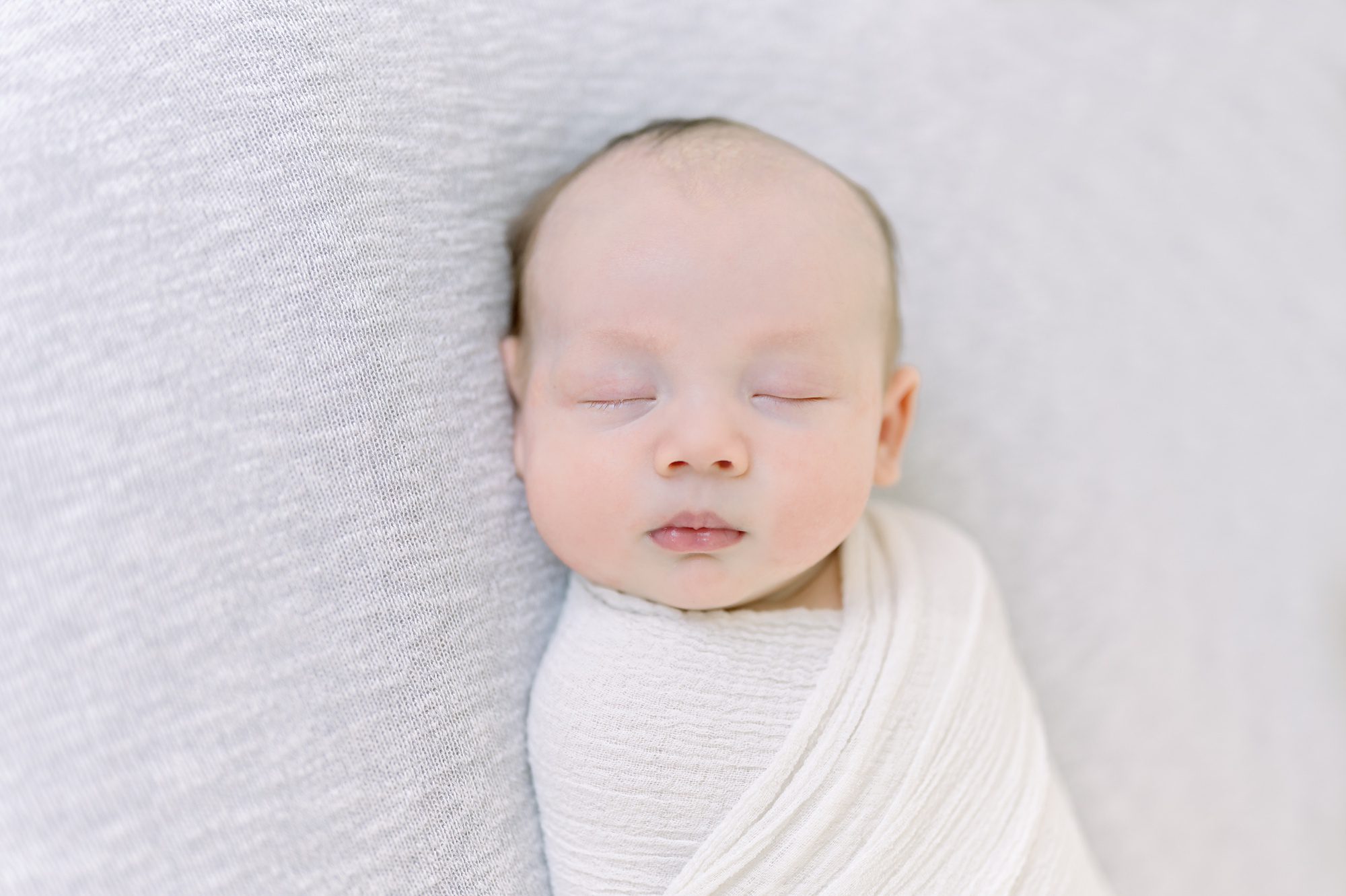 As a new family of 4, these parents get light and airy newborn photos done with their two boys in a bright white studio in Denver Colorado.