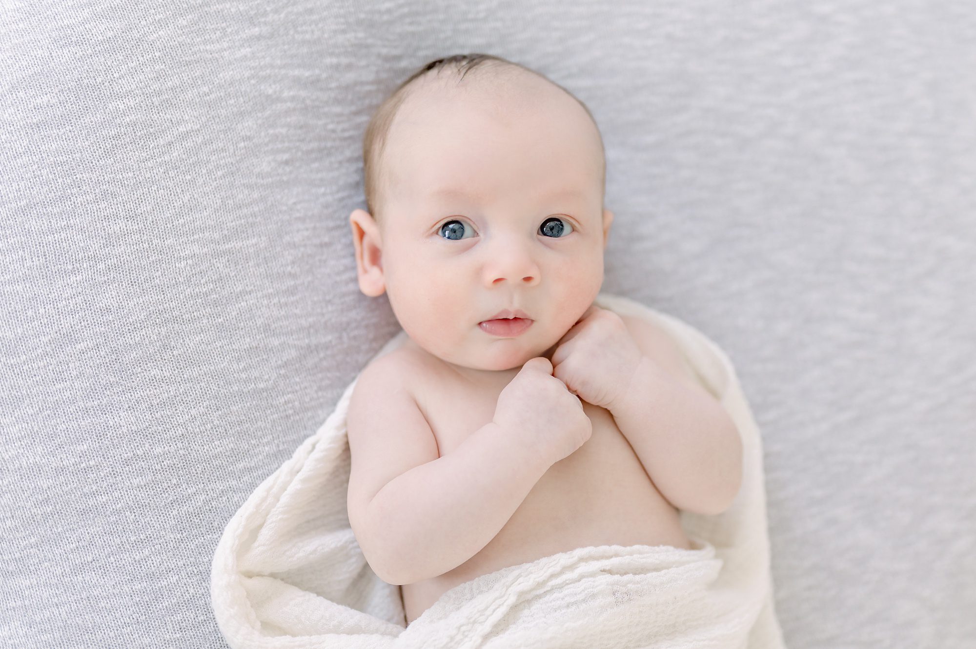 As a new family of 4, these parents get light and airy newborn photos done with their two boys in a bright white studio in Denver Colorado.