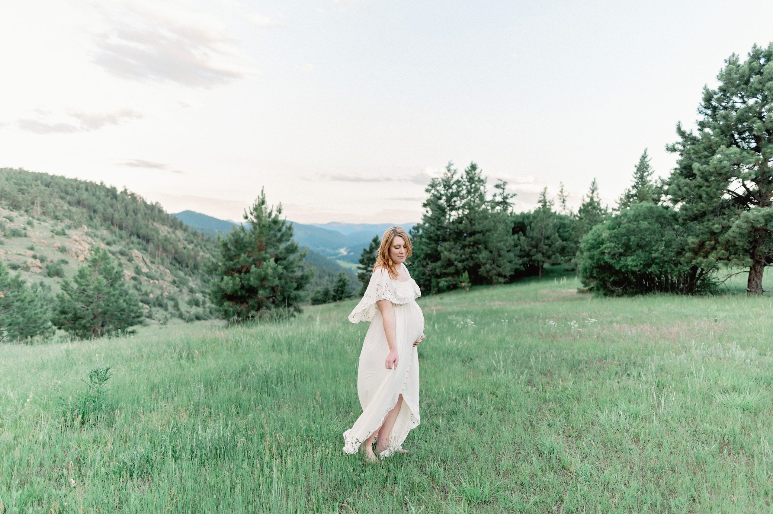 A sweet young couple expecting their first baby gets maternity photos done with the stunning backdrop of Mount Falcon in Denver, Colorado.