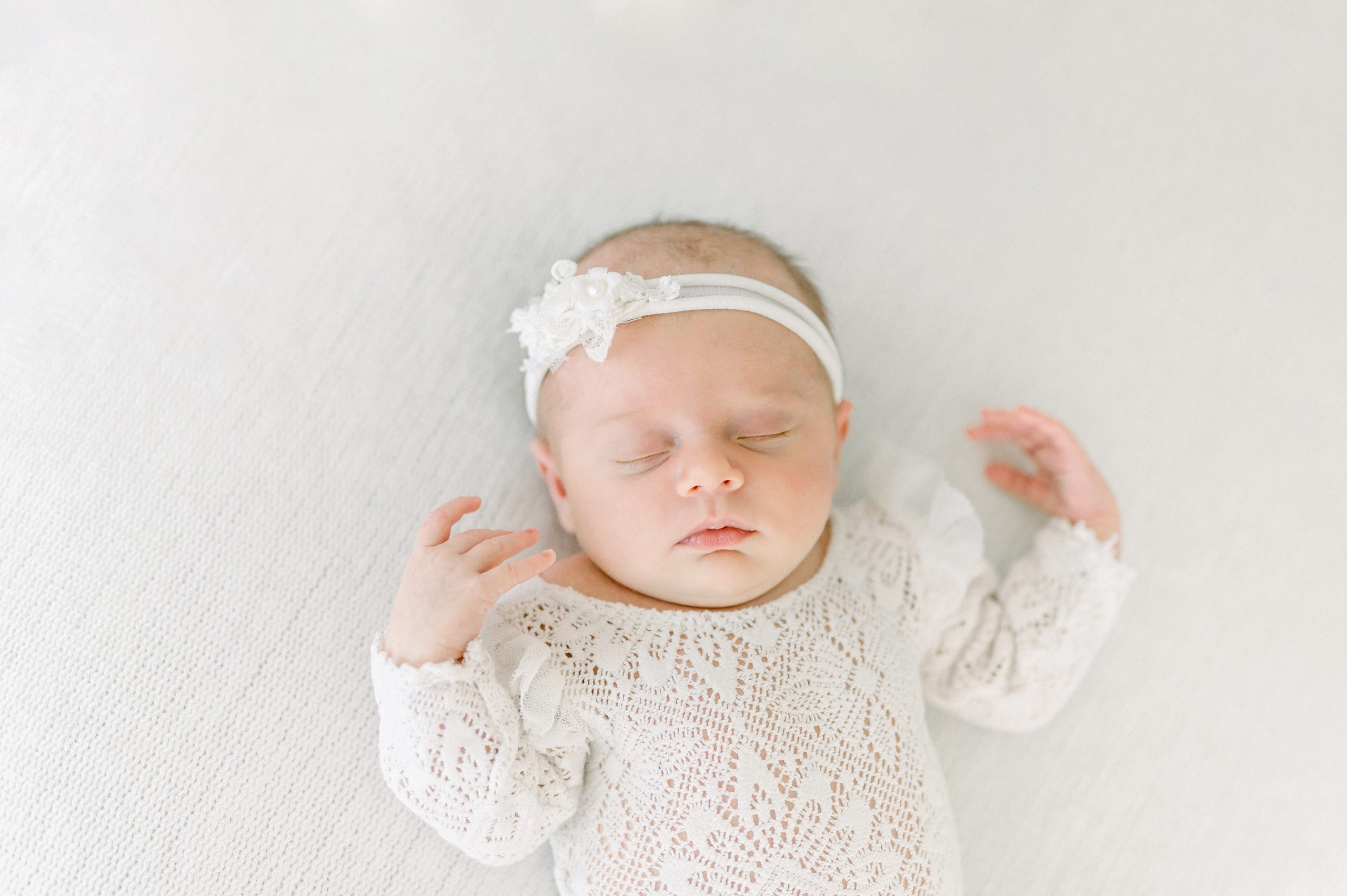 A family of 4 welcomes their new daughter by doing newborn portraits in a bright white studio in Centennial Colorado.